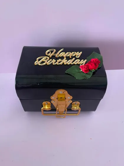 The elegant black trunk box, closed and ready for gifting. The "Happy Birthday" tag with a rose detail adds a touch of celebration.