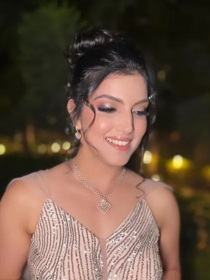 A close-up of our pretty client living in her princess era on her big day, with a glittery look and a beautiful updo.