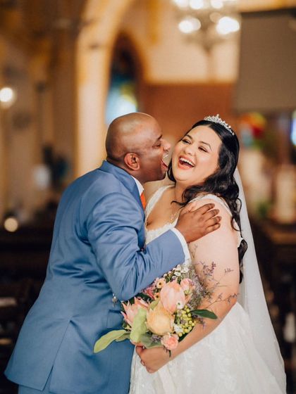The same beautiful, candid moment from a slightly different angle, capturing the pure happiness and emotion between the bride and her loved one.