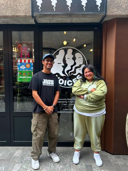 Posing outside the Voices Radio studio after my set. It was great to connect with the host and share my musical journey.