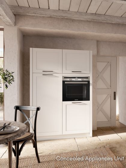 A concealed appliance unit in the RAVENNA White design. This tall cabinet seamlessly integrates an oven while maintaining the kitchen's classic, uncluttered look.