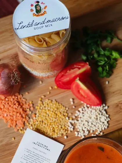 My Lentil and Macaroni Soup Mix jar, displayed with the fresh ingredients that inspired it. The jar is layered with different types of lentils and pasta, and comes with easy-to-follow cooking instructions.