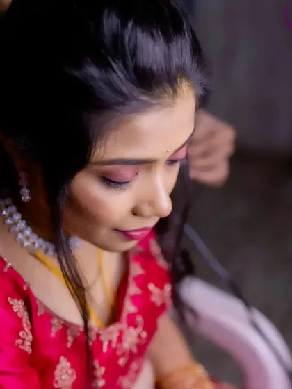 Another angle of the reception makeup application, showing the bride looking down as I work on her eyeshadow.