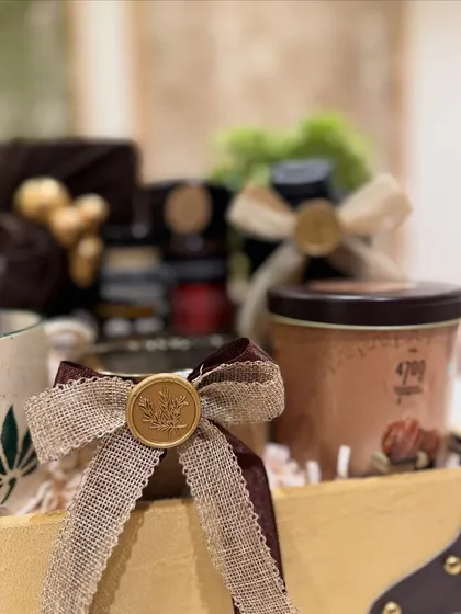 It’s all in the details. A close-up of our craftsmanship, showing a hand-tied burlap and velvet ribbon finished with a custom wax seal. We believe these small, personal touches are what transform a gift into a memorable experience.