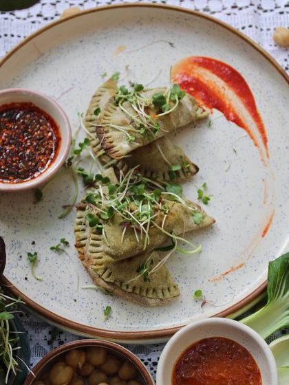 Our High Protein Calzone, beautifully plated and ready to be enjoyed. The vibrant microgreens add a fresh, nutritious touch to this hearty Italian favorite.
