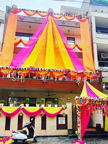 A full view of the grand house decoration, showcasing the multi-level draping and the beautifully decorated entrance tent.