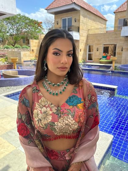 The full look against the bright blue pool, showing how the colors of the outfit and the fresh makeup come together for a perfect daytime event.