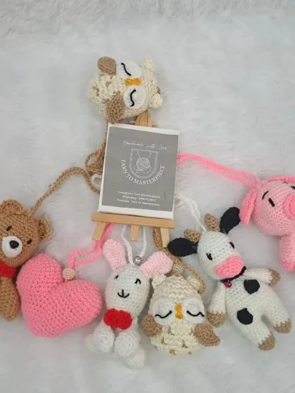This is a full set of hanging toys for a baby gym. It includes a variety of animals and shapes like a bear, pig, cow, owl, bunny, and heart.