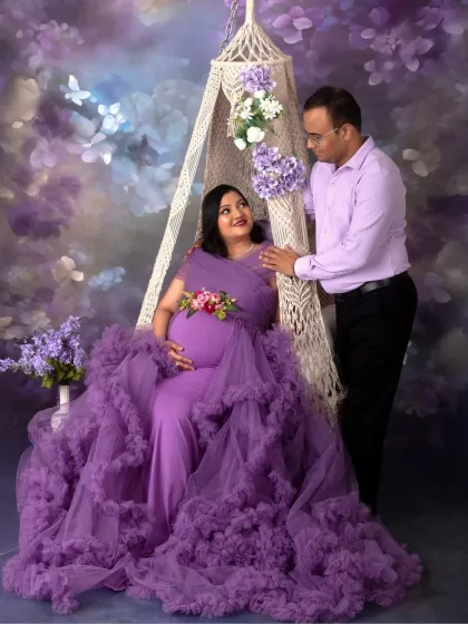 A portrait of shared joy. This couple's love for each other and their baby-to-be shines through in this beautiful shot on our purple-themed swing setup.
