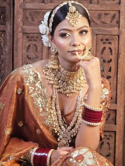 A full view of one of my stunning Polki jewellery sets paired with a rust-colored bridal lehenga. This shows how the complete set, from the matha patti to the long necklace, creates a cohesive and breathtaking look.