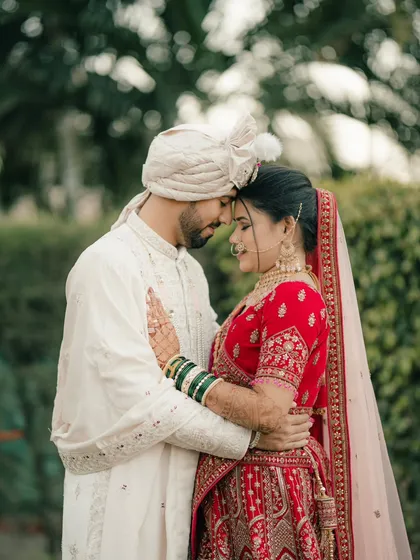 An intimate embrace, with the couple touching foreheads. This pose is perfect for capturing the deep connection and love between them.