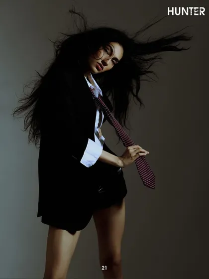 Capturing motion and attitude for the Hunter Magazine spread. The wind in her hair and the casual pull of the tie add a layer of narrative to this studio portrait, making it more than just a static fashion shot.