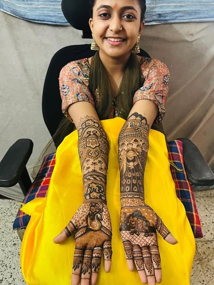 This bride is all smiles with her custom family portrait mehndi. We love creating designs that are full of personal meaning.