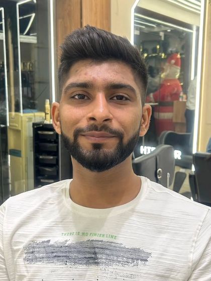 A happy client with his new haircut, a classic fade that is both stylish and professional.