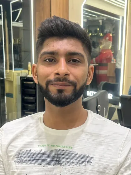 A happy client with his new haircut, a classic fade that is both stylish and professional.