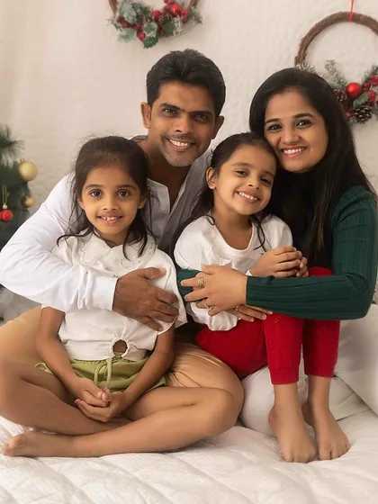 A classic Christmas-themed family portrait. The whole family snuggled together creates a warm, festive feeling that's perfect for holiday cards and memories.