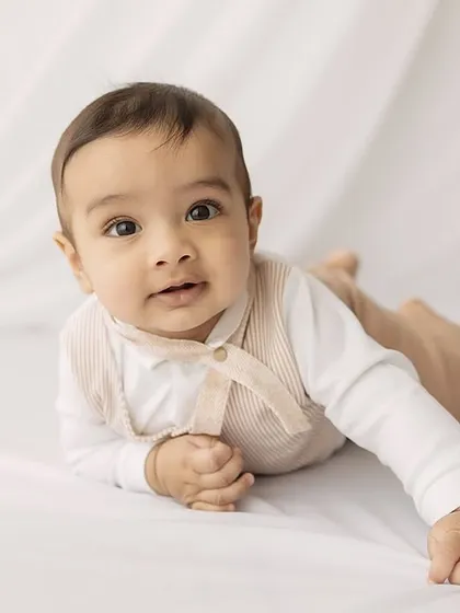 A lovely portrait of the baby pushing up during tummy time.