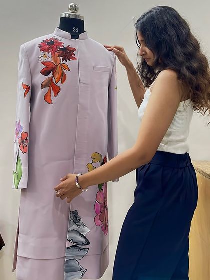 Me with a nearly finished floral sherwani. Every piece I create is a story, and this one blends traditional wear with the beauty of nature.