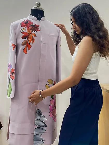 Me with a nearly finished floral sherwani. Every piece I create is a story, and this one blends traditional wear with the beauty of nature.