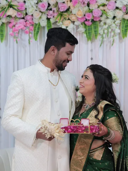 A sweet moment between the couple during the ring ceremony. Her makeup remains flawless, capturing her joyful expression.
