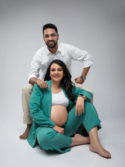 A sweet and classic portrait of the couple. Her stylish pantsuit and his simple white shirt create a modern and coordinated look.