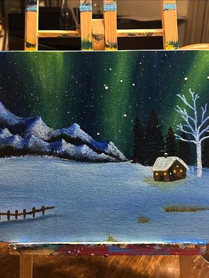 You don't need to travel to see the northern lights. This beautiful aurora borealis scene was painted by a participant, capturing the magic of a winter night on canvas.