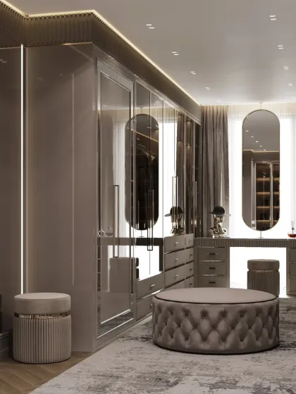The sleek design of this dark-toned closet is emphasized by the reflective surfaces and clean lines. The dual vanity stations with large, oblong mirrors add a touch of modern glamour.