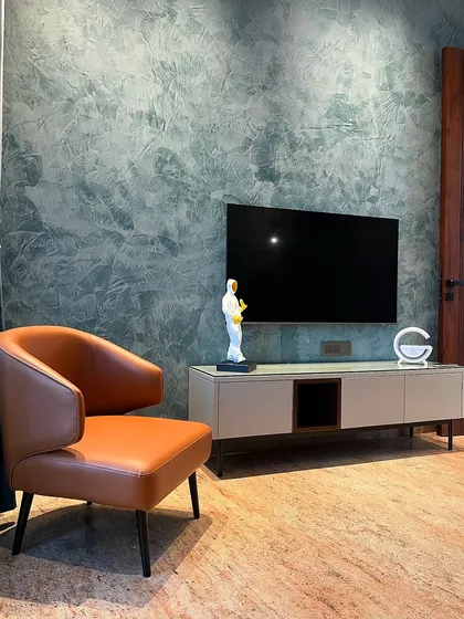 Another view of the same bedroom corner, showing the beautiful texture of the wall. This is how we use unique finishes to add character and depth to a space.