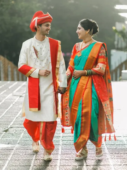 A beautiful Maharashtrian couple taking a stroll, hand in hand. We love capturing the elegance of the traditional Nauwari saree and the groom's vibrant attire.