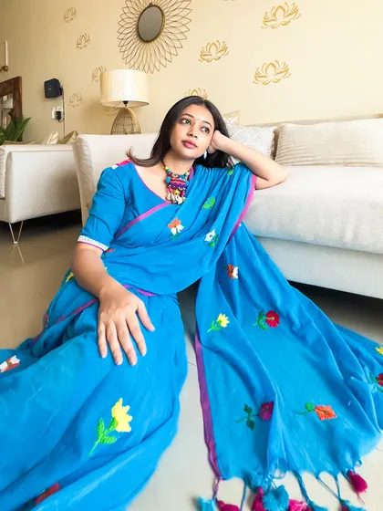 Another angle of the blue mul cotton saree, showing how it drapes beautifully even when sitting on the floor. It's a truly versatile garment.