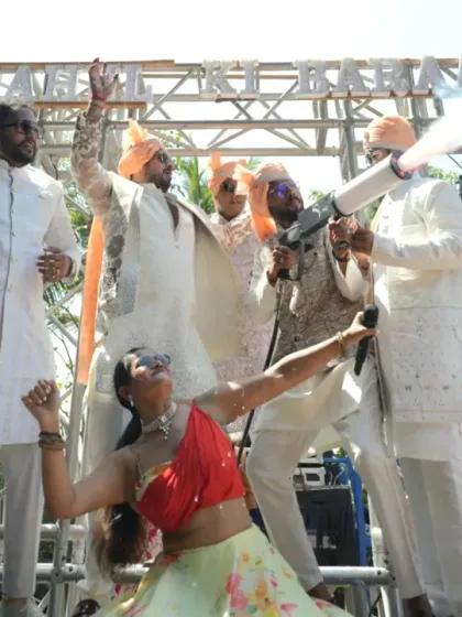 A moment of pure celebration with the groom and his friends during the baraat, complete with a party fog gun to amplify the excitement.