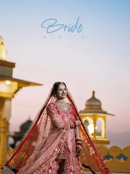 A stunning bridal portrait at dusk against a palace backdrop. The soft light of the sunset and the bride's regal pose create a truly magical and timeless image.