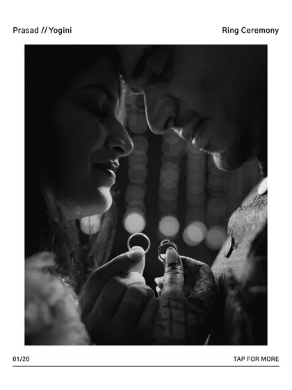 A creative black and white photo focusing on the couple holding their engagement rings, their faces blurred in an intimate moment in the background.