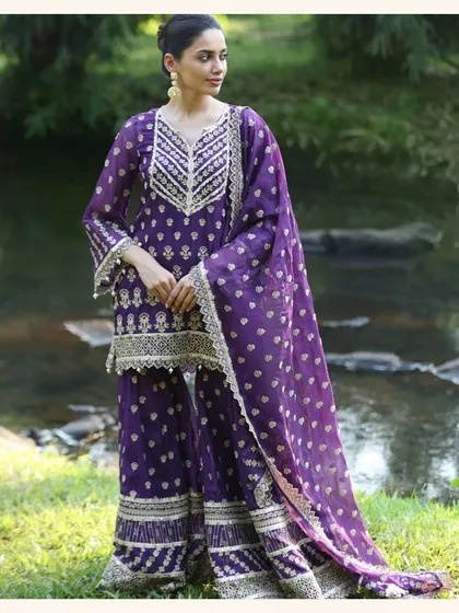 This deep purple sharara set is fit for royalty. The intricate gold embroidery and rich color make it a perfect choice for a wedding.
