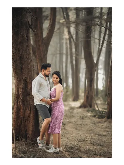 A quiet, romantic pose against a tree in a misty forest. The moody atmosphere is perfect for intimate couple shots.