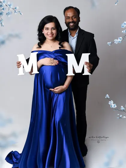 Using simple props like these letters can add a fun, personalized element to your maternity photos. It's a great way to hint at a name or simply celebrate the moment.