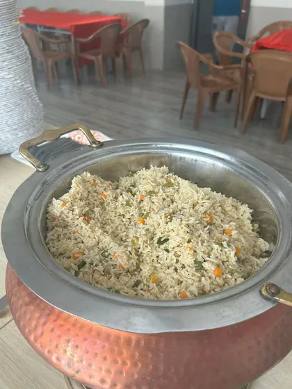 A steaming pot of vegetable fried rice, ready to be served. I ensure every dish, from the main course to the sides, is prepared fresh and kept at the perfect temperature throughout your event.