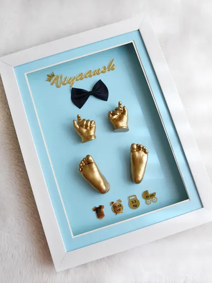 A popular and charming design for a baby boy. This keepsake for Viyaansh features golden casts on a sky blue background, personalized with his name, a little bow tie, and icons representing his birth details.
