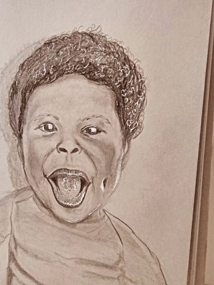 Capturing the pure joy of a child's expression is a magical process. This pencil portrait sketch focuses on capturing a candid, happy moment.