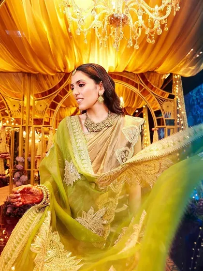 This gorgeous Masaba saree in olive green and gold is styled with heirloom jewelry, showing how you can mix designer rentals with personal pieces for a unique look.