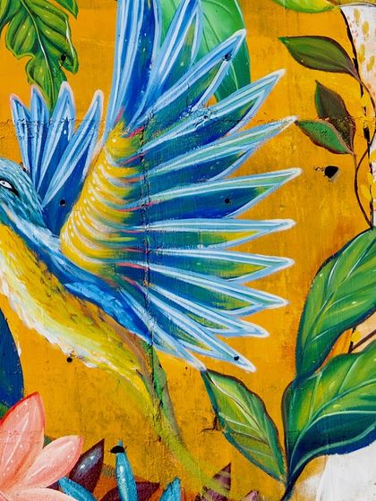 A close-up of the vibrant blue and yellow bird in the Coorg mural. I love using bold, expressive colors to depict nature's beauty.