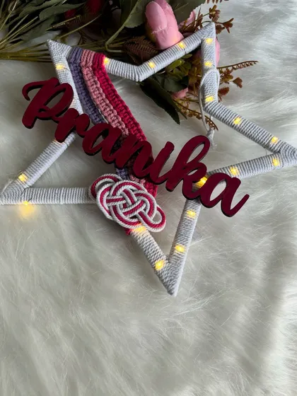 An angled view of the lit-up 'Pranika' star hanging, showing how it can brighten up a space.