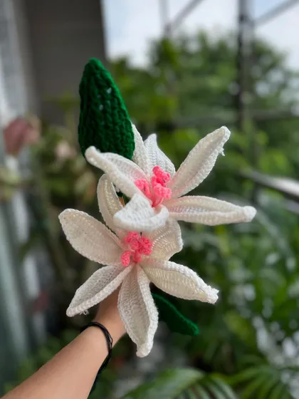 Another look at our stunning crochet lilies, showing the vibrant green leaves and the delicate, handcrafted petals.
