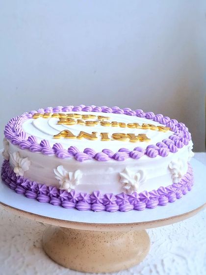 A traditional rich fruit cake covered in marzipan and royal icing. I teach the classic techniques for piping shell borders and creating a smooth, swirled top.