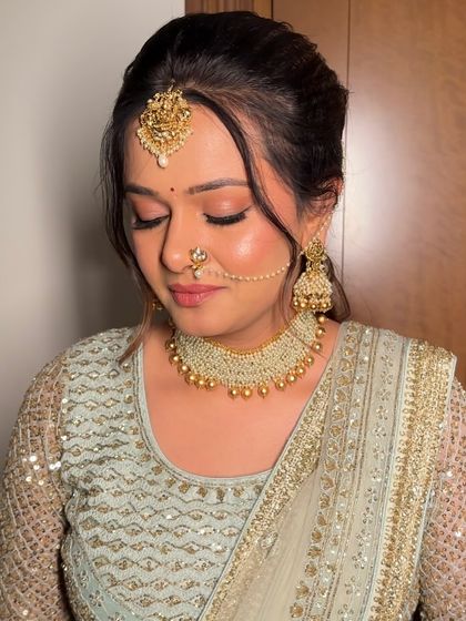 A close-up of the eye makeup, featuring a beautiful blend of pink and gold shimmer. The look is soft, dreamy, and perfect for a daytime wedding.