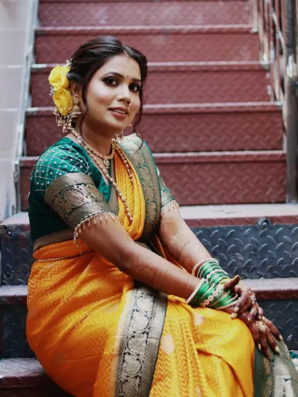I love creating the perfect Maharashtrian bridal look. Here, I focused on a soft, glowing base to let her natural beauty shine, paired with a classic hairstyle and beautiful yellow flowers. This look is ideal for a traditional wedding ceremony.