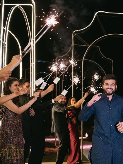 A fun and celebratory entrance with guests holding up sparklers to create a tunnel of light. This is a fantastic way to involve your loved ones in your entry and create a magical, photogenic moment.