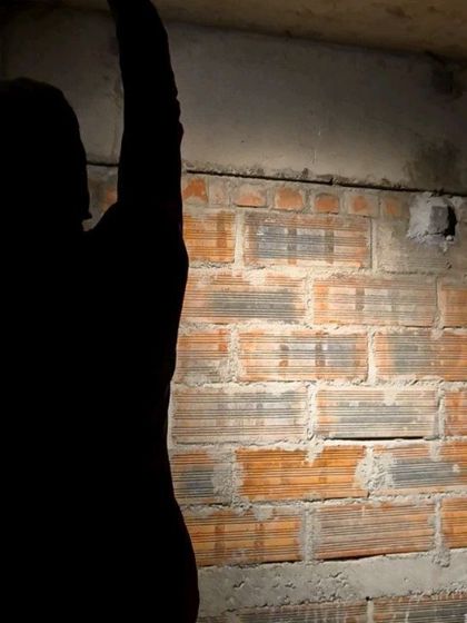 A silhouette of a team member adjusting a fixture during a site mock-up. This hands-on testing is a crucial part of our process, as it allows us to see the light in the real world, not just on a computer screen.