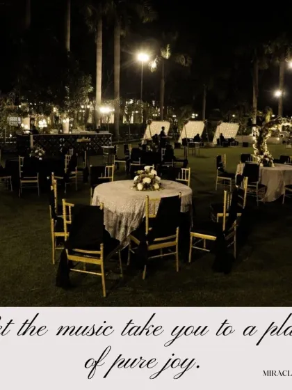 A wide view of the outdoor seating for a Sangeet, with tables arranged under the open sky for a relaxed yet elegant feel.