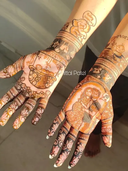 Another angle of the couple's baby shower mehndi. This view shows the cute elephant and baby figures on the arms, complementing the main portraits on the palms.